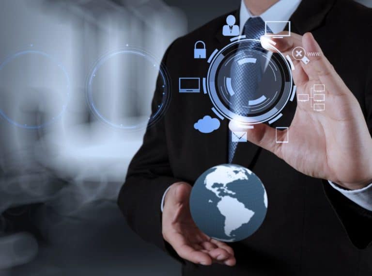 corma- A man in a suit is holding a globe in his hand while conducting a background check on potential business partner.